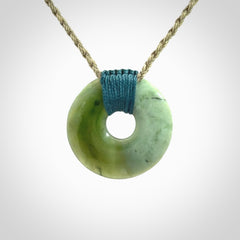 These are medium sized pendants - very finely carved. They are New Zealand Jade discs with a centre hole. It is suspended from a cord which is adjustable. These are beautiful pieces of expressive jade jewellery. Unique New Zealand made pendants for men and women. Perfect gifts for all.