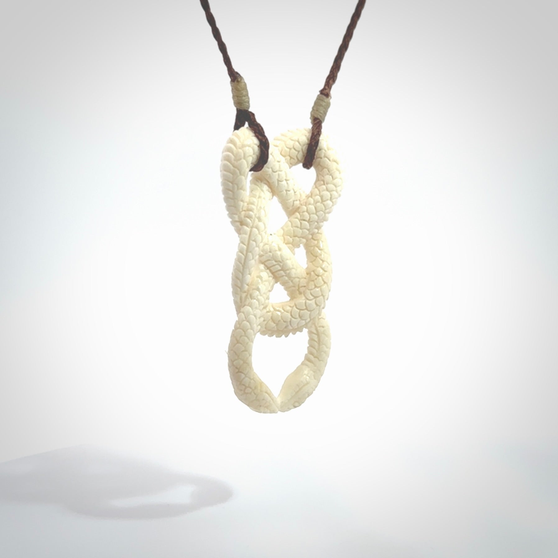 Hand carved bone double snake pendant. Hand carved by NZ Pacific. Free postage worldwide. Hand made double snake necklace from bone. Double snake necklace for men and women.
