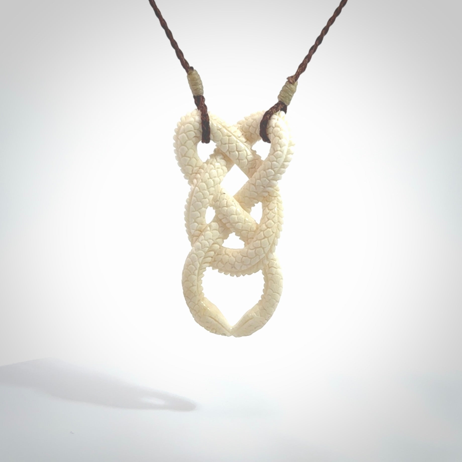 Hand carved bone double snake pendant. Hand carved by NZ Pacific. Free postage worldwide. Hand made double snake necklace from bone. Double snake necklace for men and women.