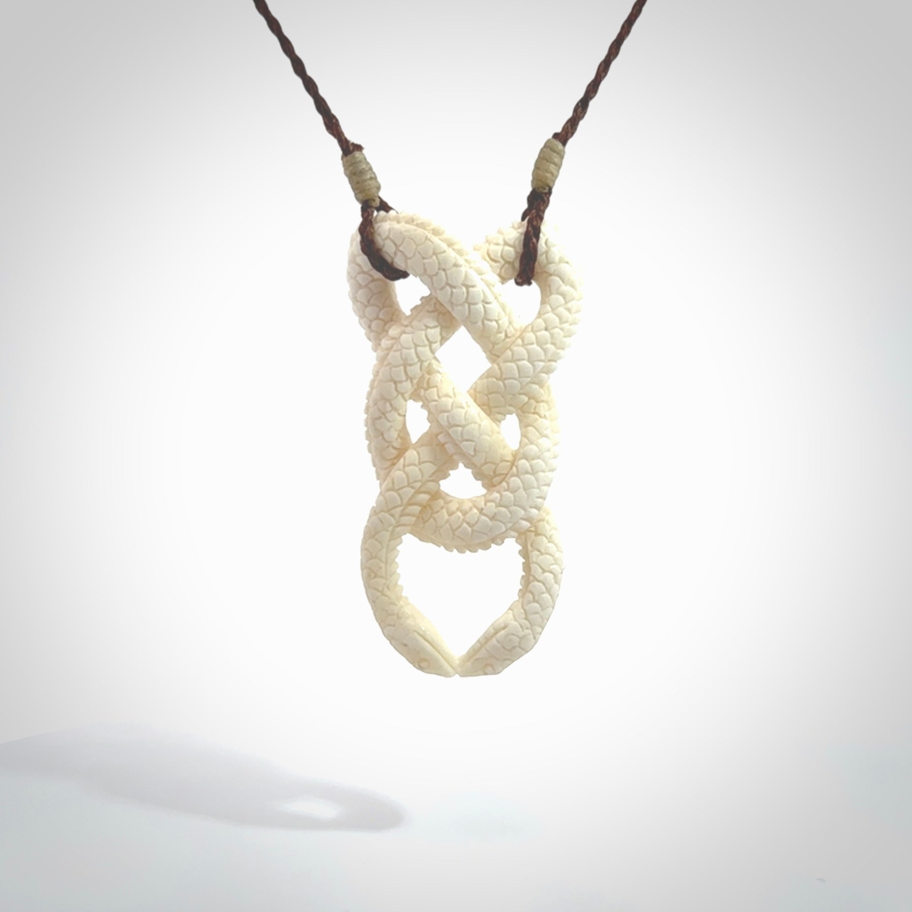 Hand carved bone double snake pendant. Hand carved by NZ Pacific. Free postage worldwide. Hand made double snake necklace from bone. Double snake necklace for men and women.