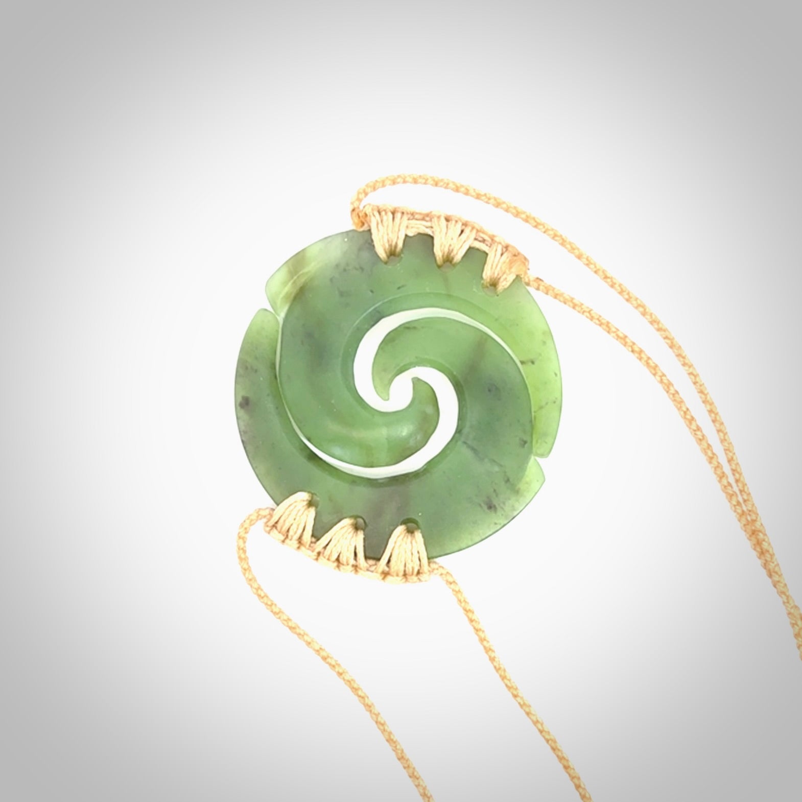 Two Jade koru partner pendants. Necklace hand carved in New Zealand jade, pounamu by NZ Pacific. These are partner pendants that represent partnerships. The jade is a beautiful bright green and we have suspended these on adjustable cords so that you can position the pendant where it suits you best. Postage is included in the price and we ship worldwide.