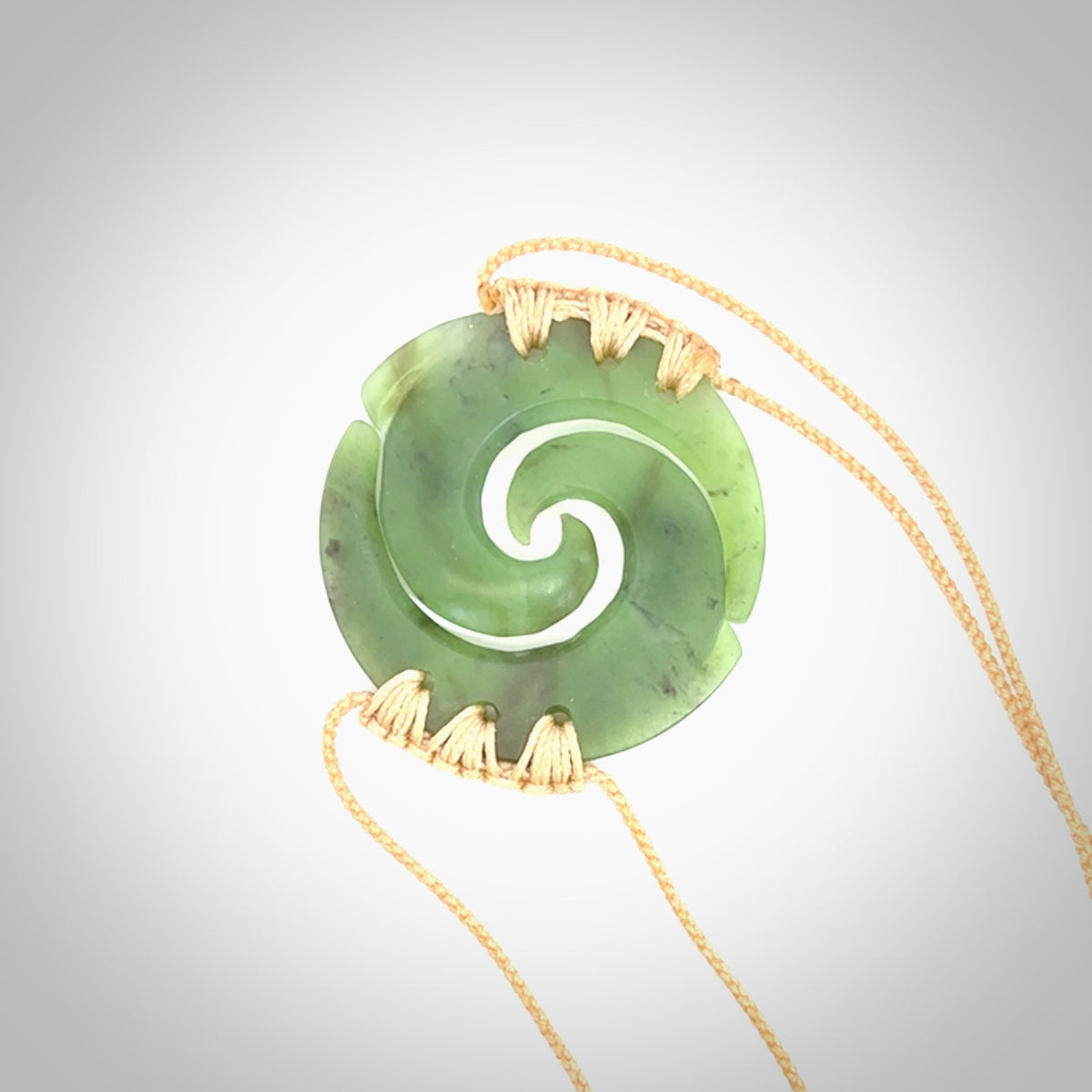 Two Jade koru partner pendants. Necklace hand carved in New Zealand jade, pounamu by NZ Pacific. These are partner pendants that represent partnerships. The jade is a beautiful bright green and we have suspended these on adjustable cords so that you can position the pendant where it suits you best. Postage is included in the price and we ship worldwide.