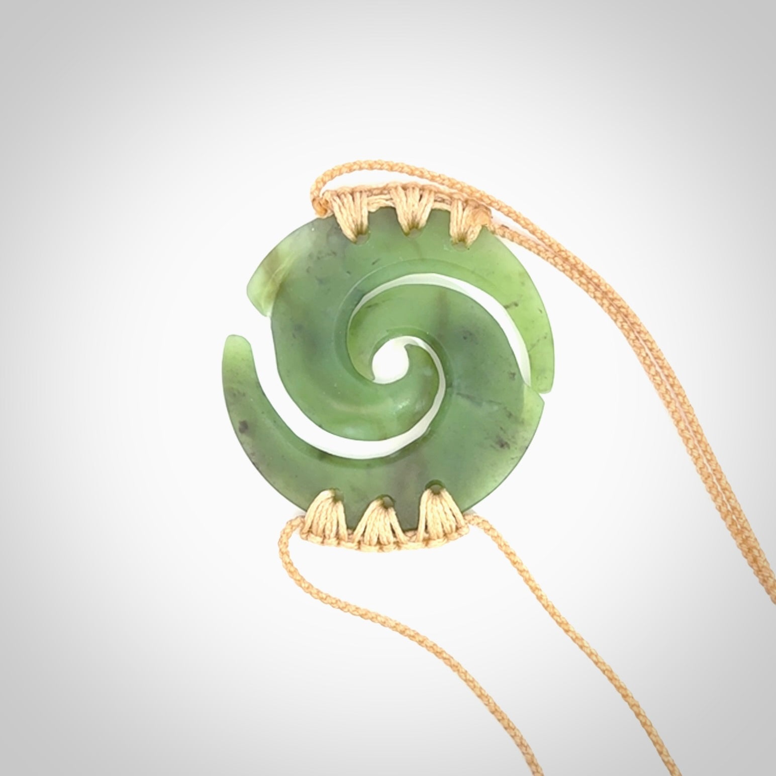 Two Jade koru partner pendants. Necklace hand carved in New Zealand jade, pounamu by NZ Pacific. These are partner pendants that represent partnerships. The jade is a beautiful bright green and we have suspended these on adjustable cords so that you can position the pendant where it suits you best. Postage is included in the price and we ship worldwide.