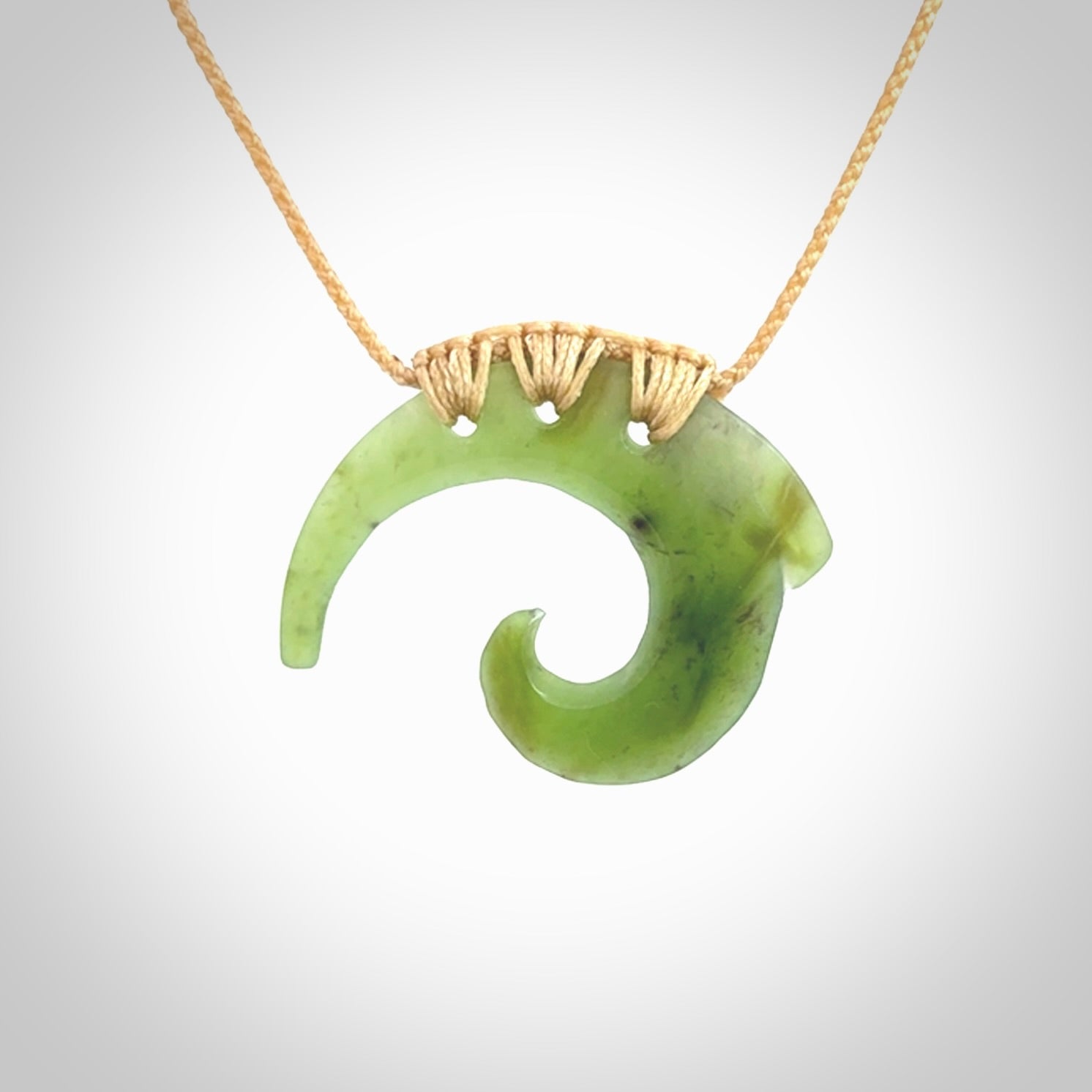 Two Jade koru partner pendants. Necklace hand carved in New Zealand jade, pounamu by NZ Pacific. These are partner pendants that represent partnerships. The jade is a beautiful bright green and we have suspended these on adjustable cords so that you can position the pendant where it suits you best. Postage is included in the price and we ship worldwide.