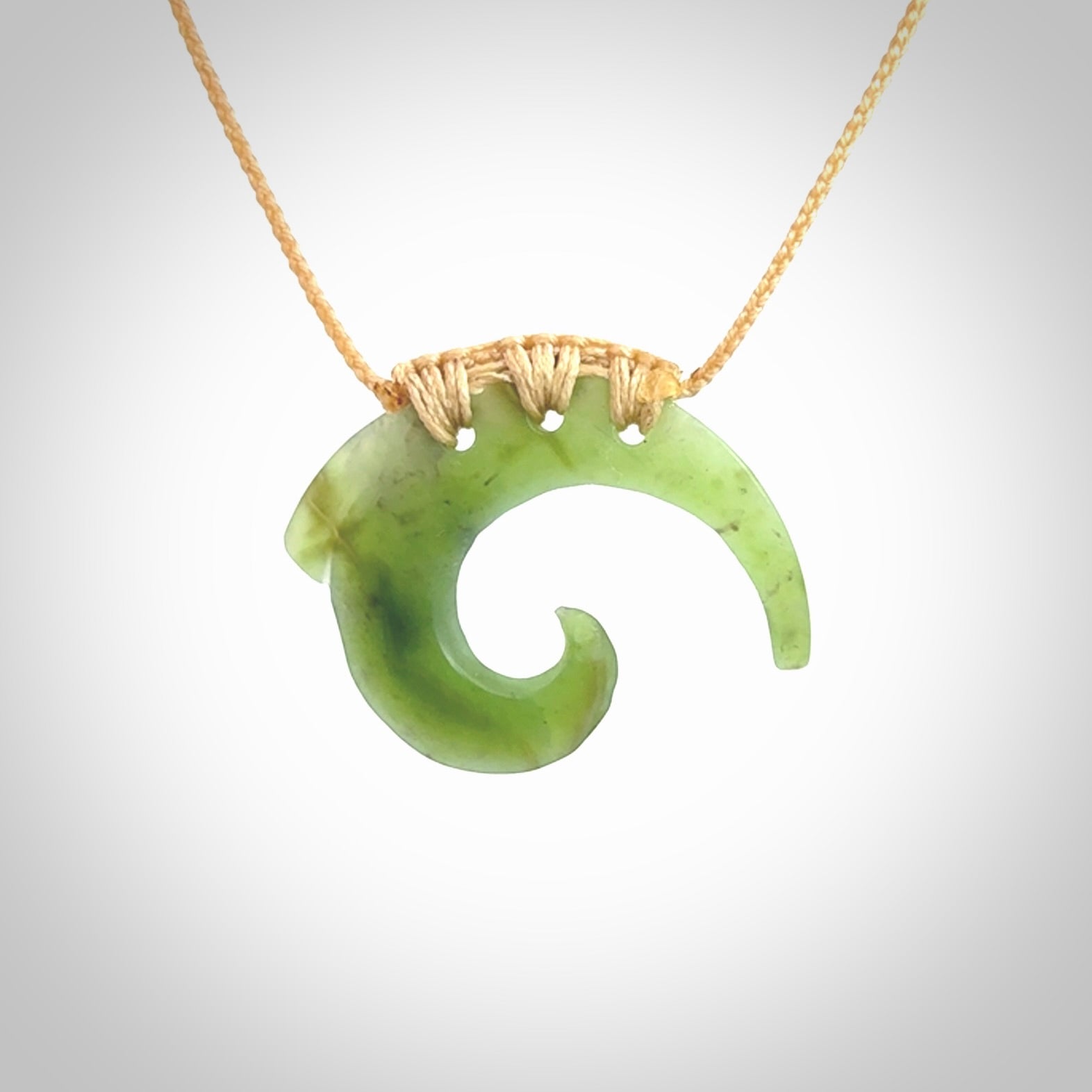 Two Jade koru partner pendants. Necklace hand carved in New Zealand jade, pounamu by NZ Pacific. These are partner pendants that represent partnerships. The jade is a beautiful bright green and we have suspended these on adjustable cords so that you can position the pendant where it suits you best. Postage is included in the price and we ship worldwide.