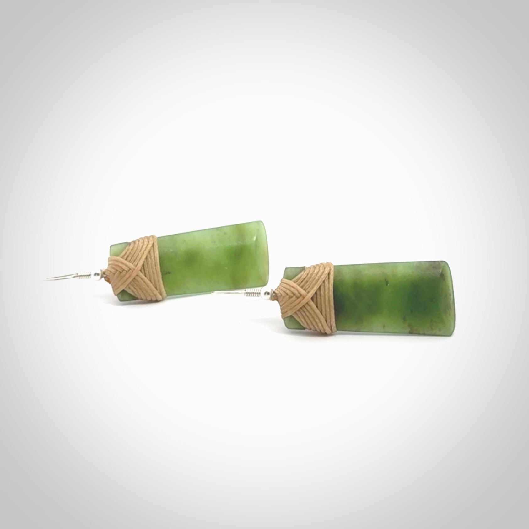 Hand crafted large, New Zealand Jade toki earrings with Sterling Silver Hooks. Jade toki earrings, packaged in a woven kete pouch.