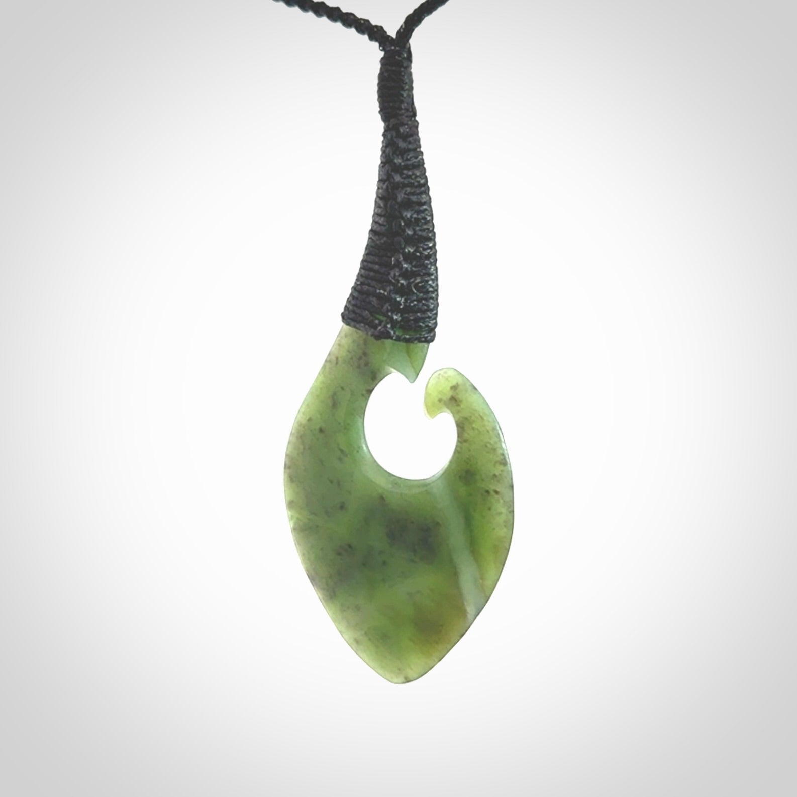Hand carved jade koru pendant. Hand made in New Zealand by Donna Summers.