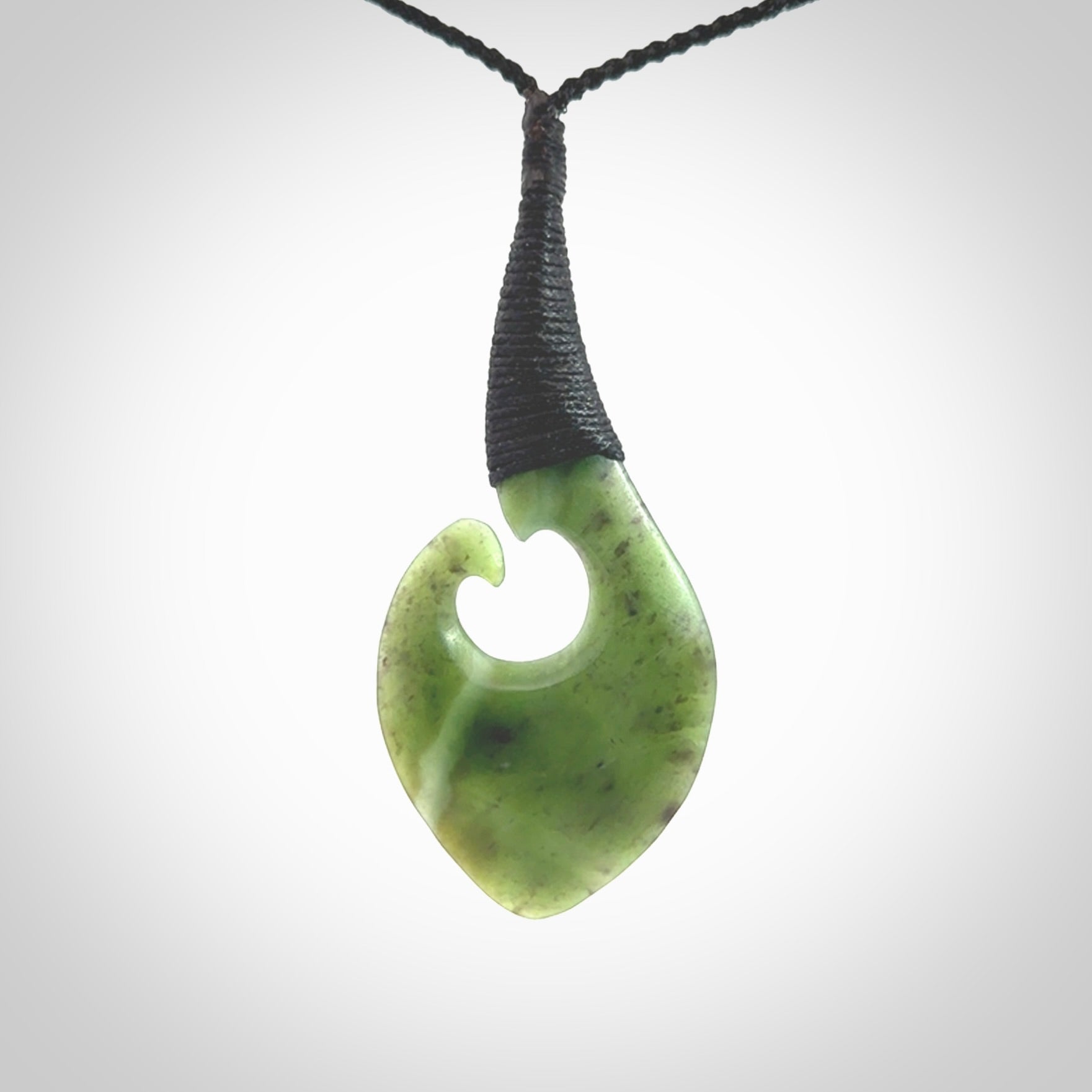 Hand carved jade koru pendant. Hand made in New Zealand by Donna Summers.