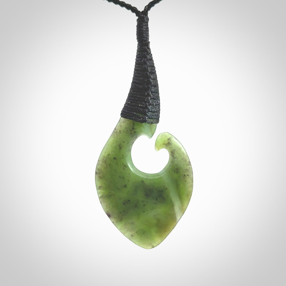 Hand carved jade koru pendant. Hand made in New Zealand by Donna Summers.
