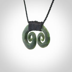Hand carved contemporary jade double koru jewellery. Made by Donna Summers for NZ Pacific from New Zealand greenstone.