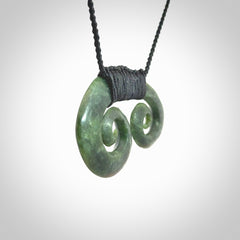 Hand carved contemporary jade double koru jewellery. Made by Donna Summers for NZ Pacific from New Zealand greenstone.