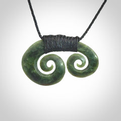 Hand carved contemporary jade double koru jewellery. Made by Donna Summers for NZ Pacific from New Zealand greenstone.