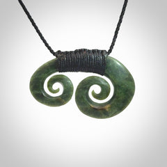 Hand carved contemporary jade double koru jewellery. Made by Donna Summers for NZ Pacific from New Zealand greenstone.