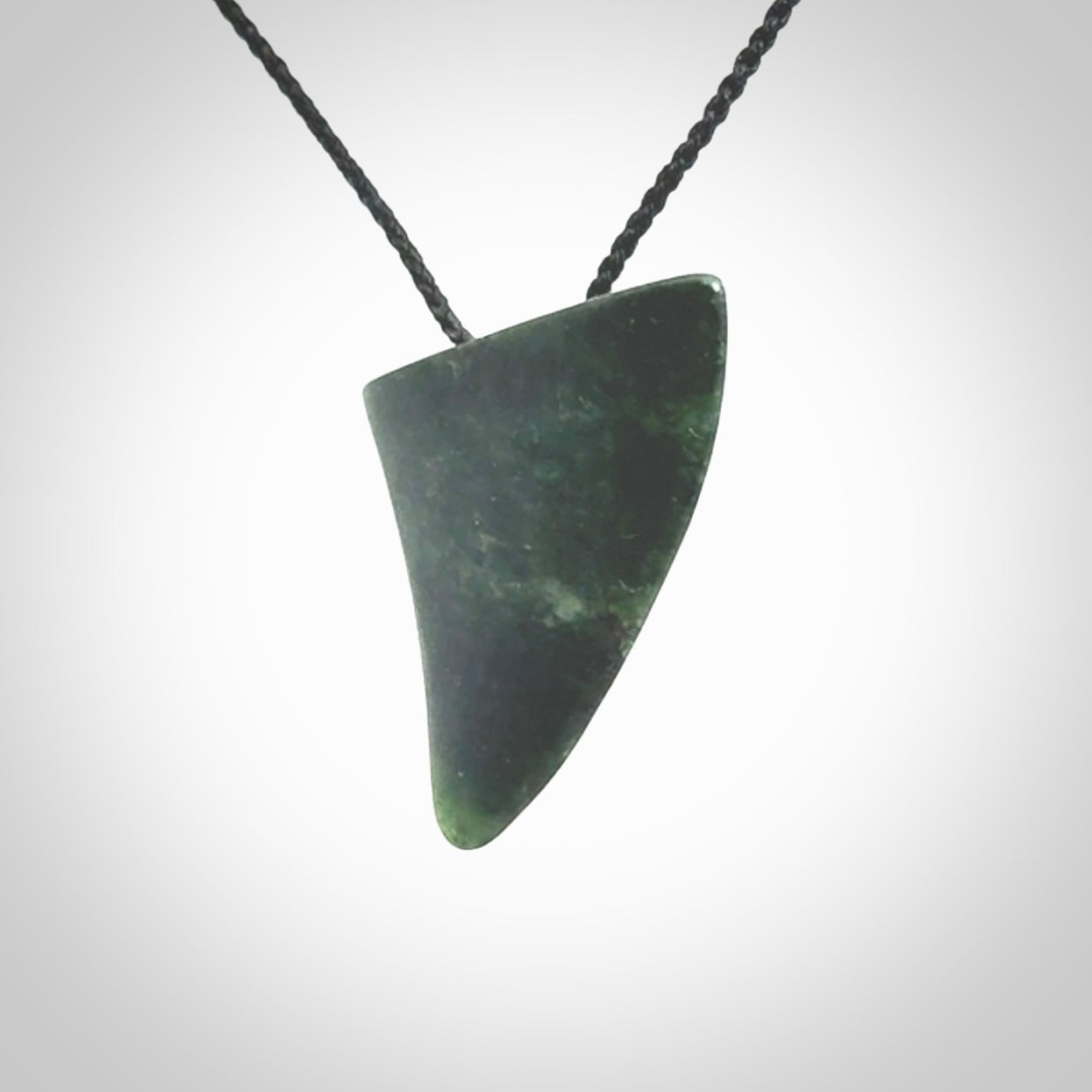 This is a lovely New Zealand Jade, pounamu drop pendant. It is bound with an adjustable Black coloured cord which is length adjustable.