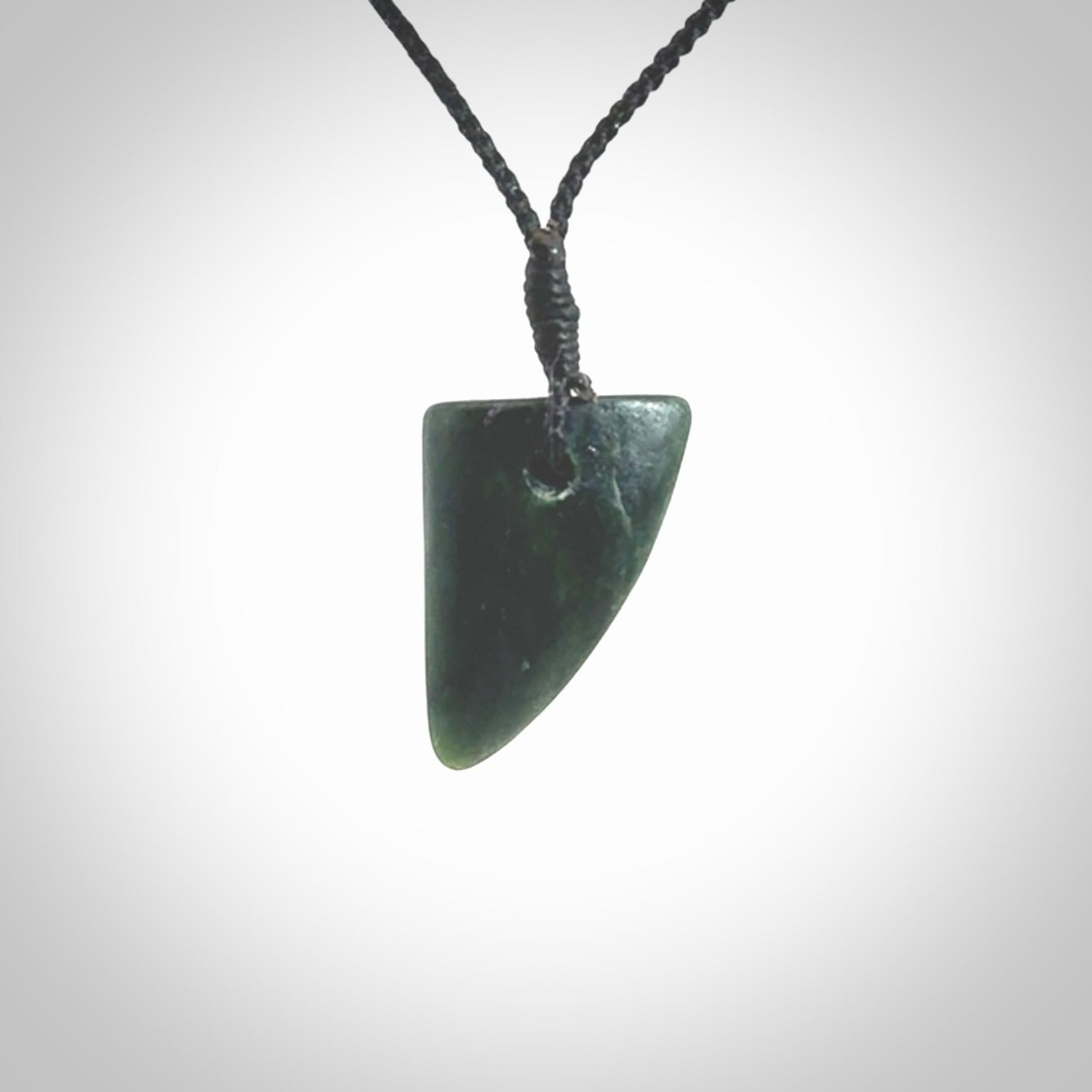 This is a lovely New Zealand Jade, pounamu drop pendant. It is bound with an adjustable Black coloured cord which is length adjustable.