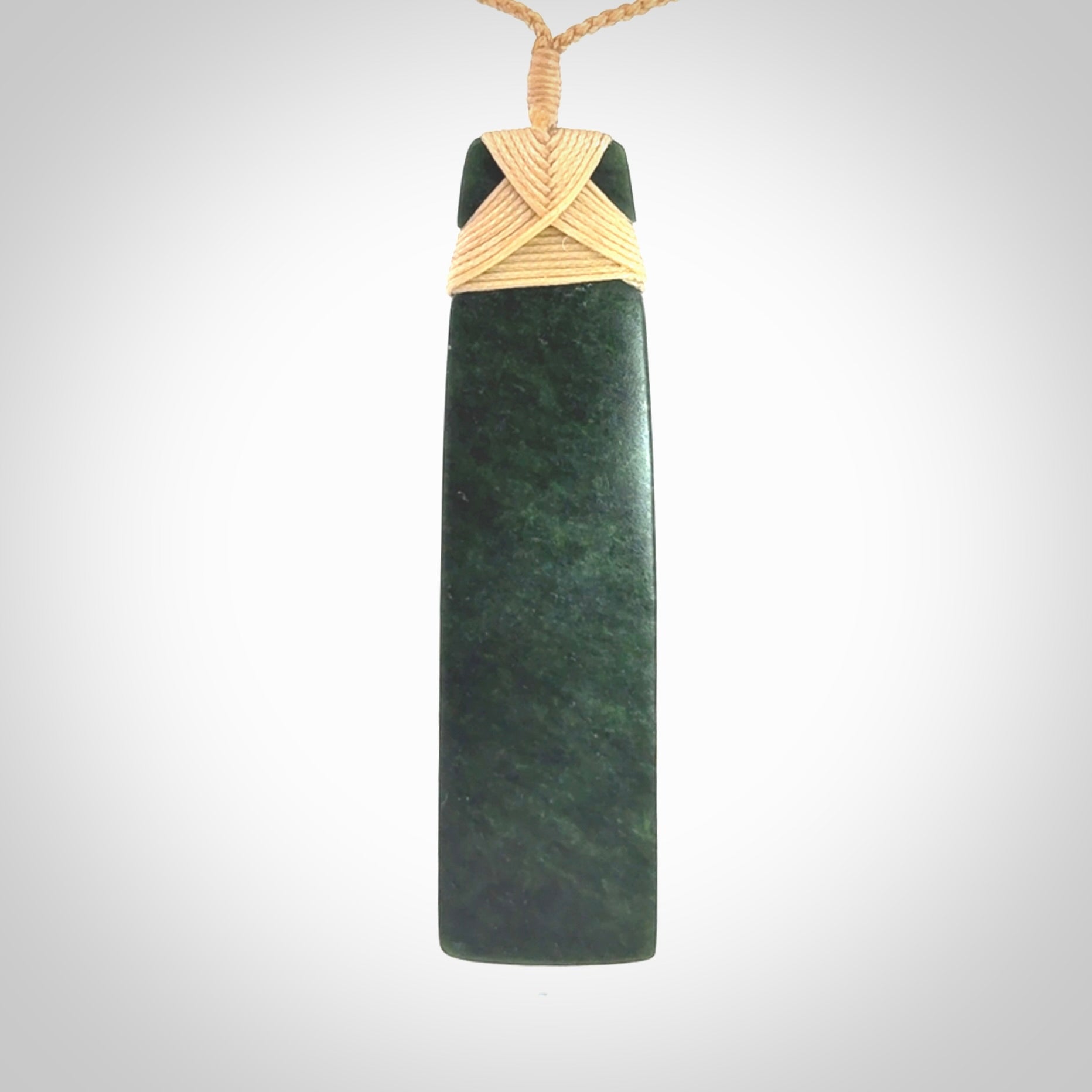 Hand carved from a lovely piece of local New Zealand Jade. We have suspended this from a 3-plait beige cord which can be adjusted with a couple of slip knots.
