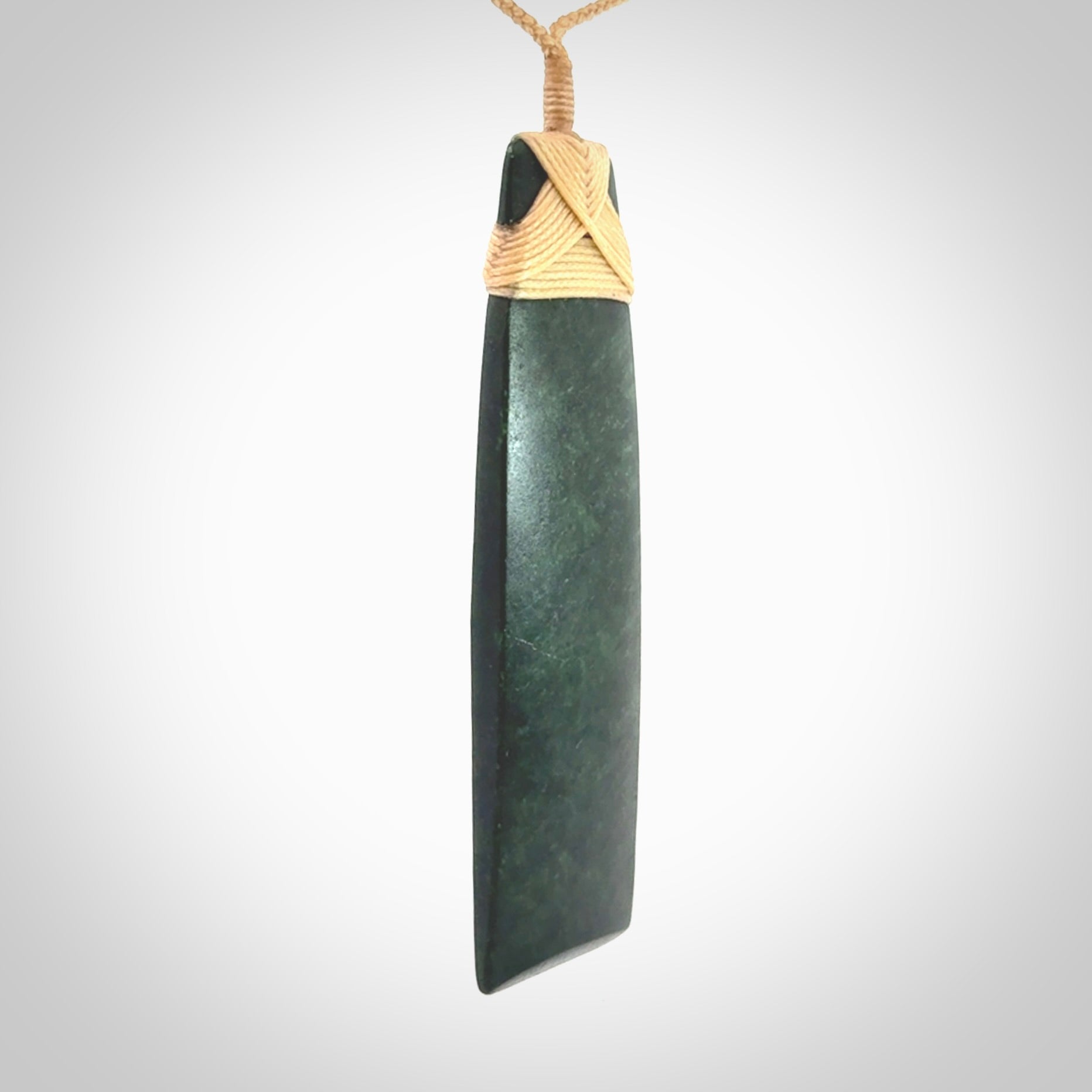 Hand carved from a lovely piece of local New Zealand Jade. We have suspended this from a 3-plait beige cord which can be adjusted with a couple of slip knots.