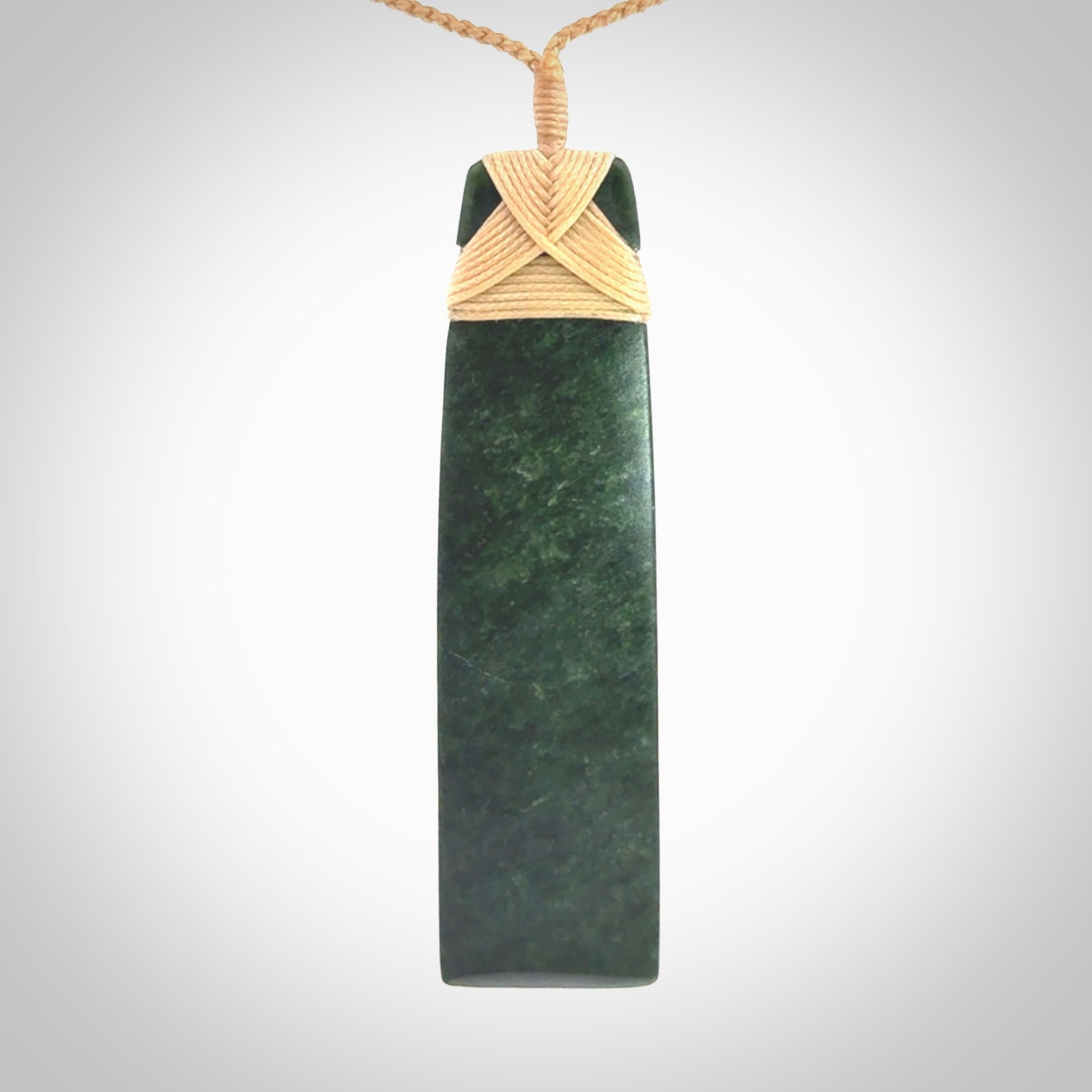 Hand carved from a lovely piece of local New Zealand Jade. We have suspended this from a 3-plait beige cord which can be adjusted with a couple of slip knots.