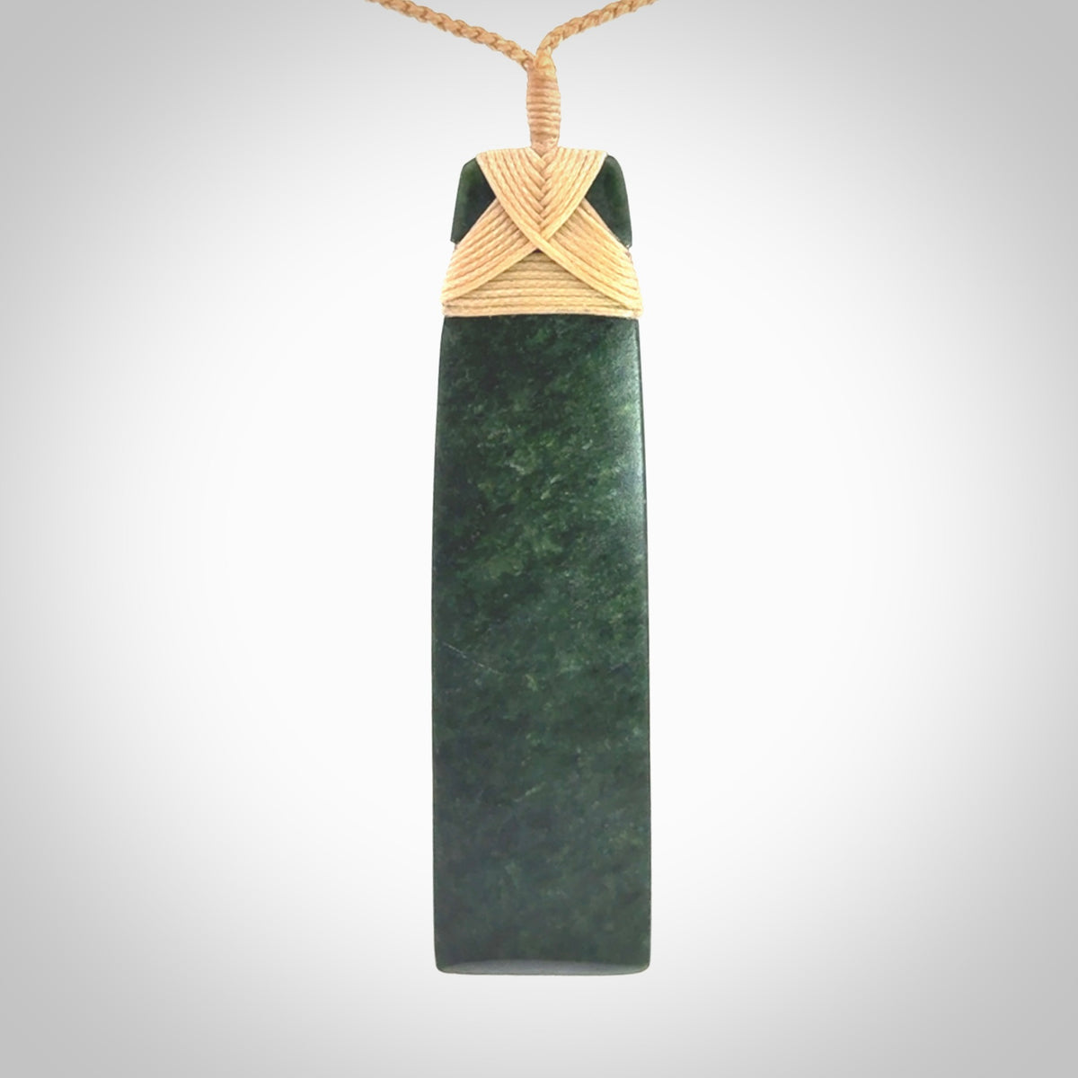 Hand carved from a lovely piece of local New Zealand Jade. We have suspended this from a 3-plait beige cord which can be adjusted with a couple of slip knots.