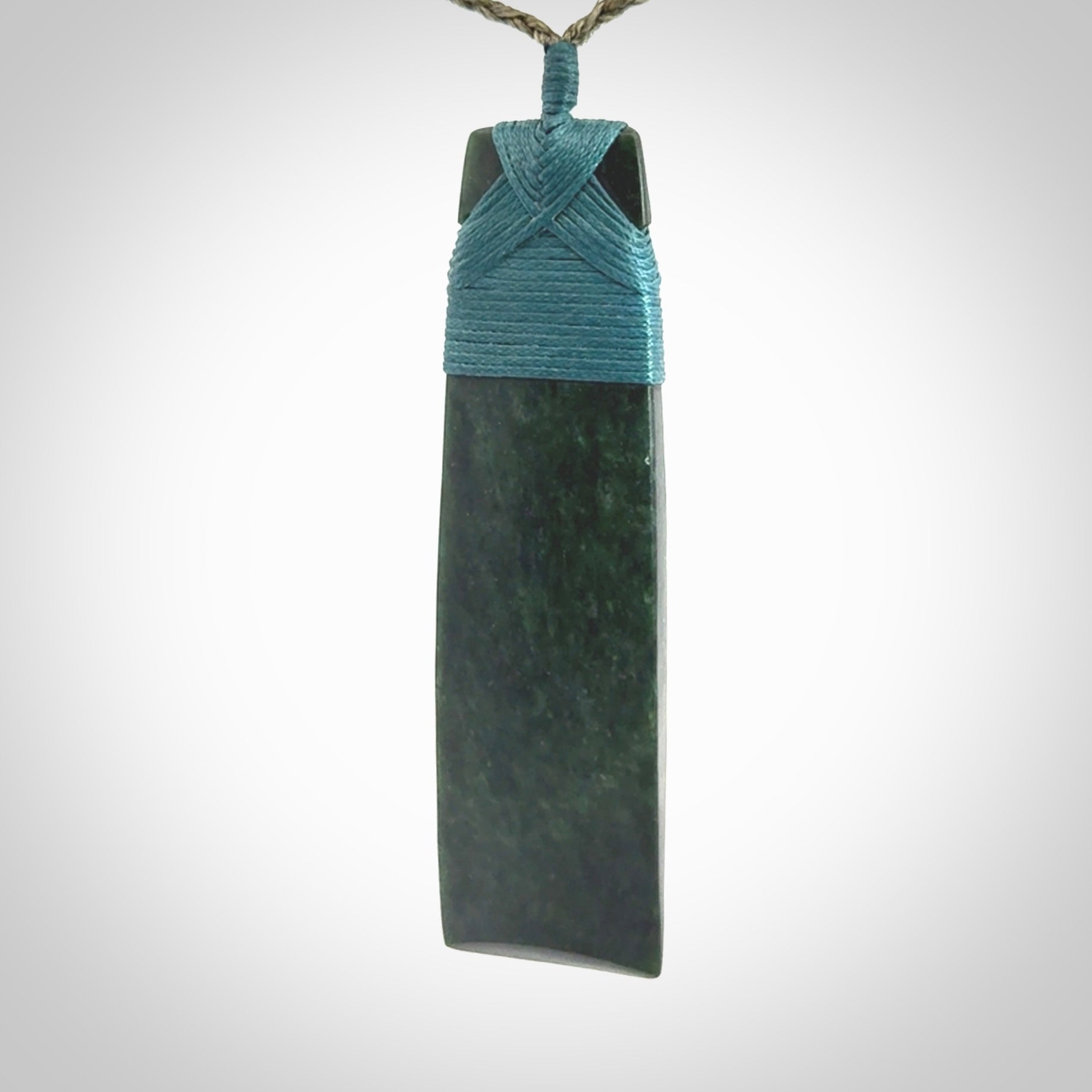 Hand carved from a lovely piece of local New Zealand Jade. We have suspended this from a olive cord which can be adjusted with a couple of slip knots.