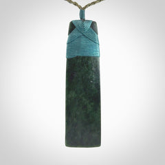 Hand carved from a lovely piece of local New Zealand Jade. We have suspended this from a olive cord which can be adjusted with a couple of slip knots.