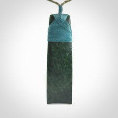 Hand carved from a lovely piece of local New Zealand Jade. We have suspended this from a olive cord which can be adjusted with a couple of slip knots.