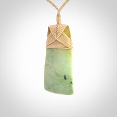 Hand carved from a lovely piece of local New Zealand flower Jade. We have suspended this from a 4-plait beige cord which can be adjusted with a couple of slip knots and beige binding.