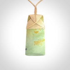 Hand carved from a lovely piece of local New Zealand flower Jade. We have suspended this from a 4-plait beige cord which can be adjusted with a couple of slip knots and beige binding.