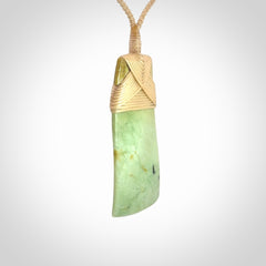 Hand carved from a lovely piece of local New Zealand flower Jade. We have suspended this from a 4-plait beige cord which can be adjusted with a couple of slip knots and beige binding.