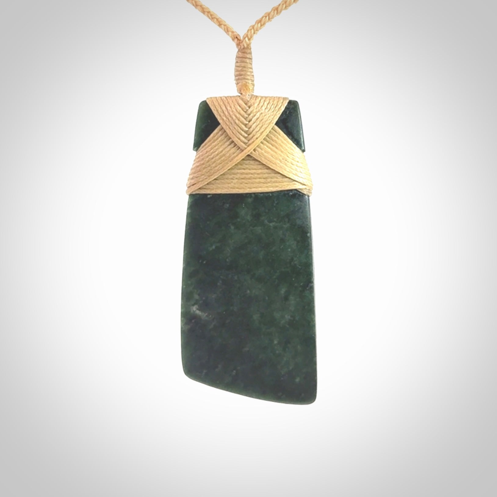Hand carved from a lovely piece of local New Zealand Jade. We have suspended this from a 3-plait beige cord which can be adjusted with a couple of slip knots.