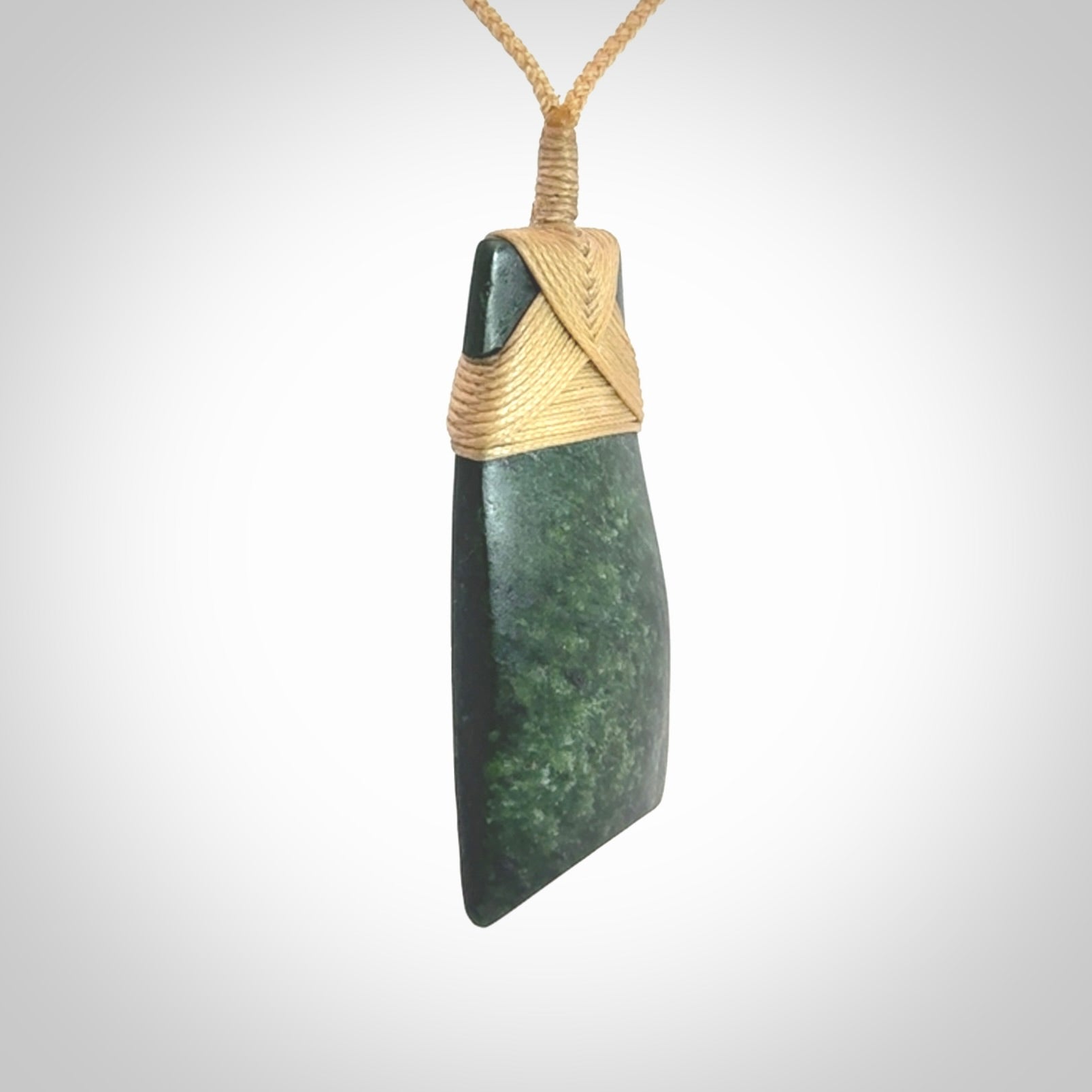 Hand carved from a lovely piece of local New Zealand Jade. We have suspended this from a 3-plait beige cord which can be adjusted with a couple of slip knots.