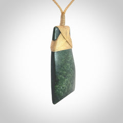 Hand carved from a lovely piece of local New Zealand Jade. We have suspended this from a 3-plait beige cord which can be adjusted with a couple of slip knots.