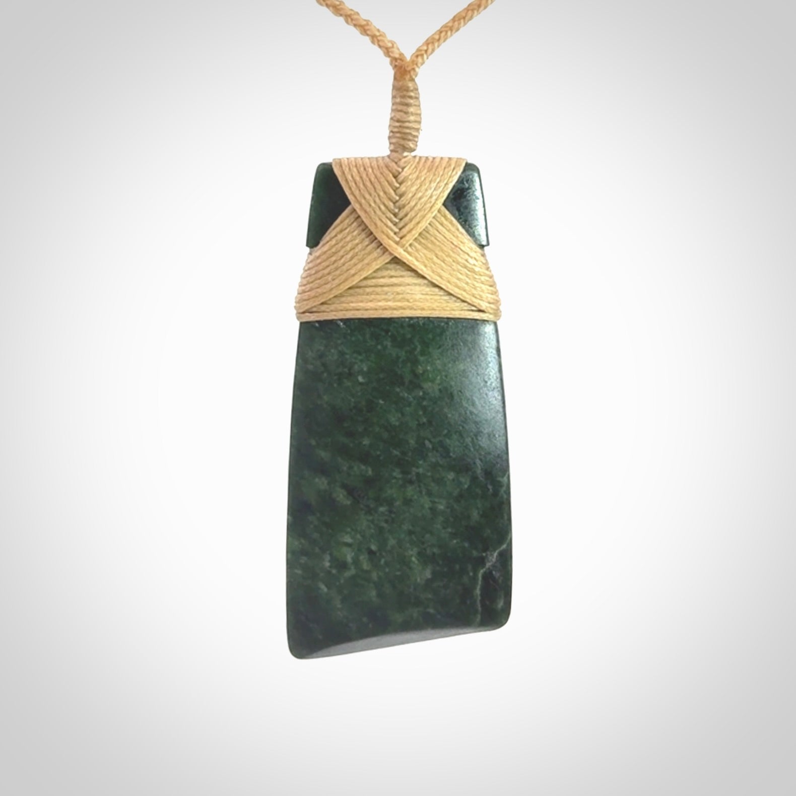 Hand carved from a lovely piece of local New Zealand Jade. We have suspended this from a 3-plait beige cord which can be adjusted with a couple of slip knots.