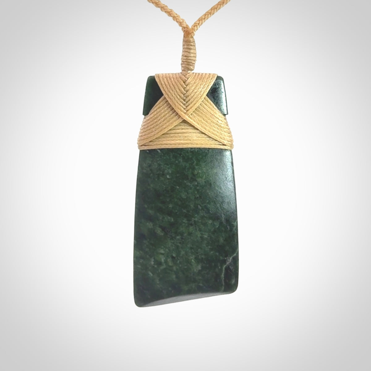 Hand carved from a lovely piece of local New Zealand Jade. We have suspended this from a 3-plait beige cord which can be adjusted with a couple of slip knots.