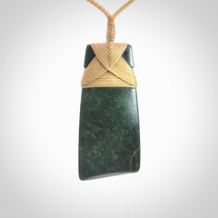 Hand carved from a lovely piece of local New Zealand Jade. We have suspended this from a 3-plait beige cord which can be adjusted with a couple of slip knots.