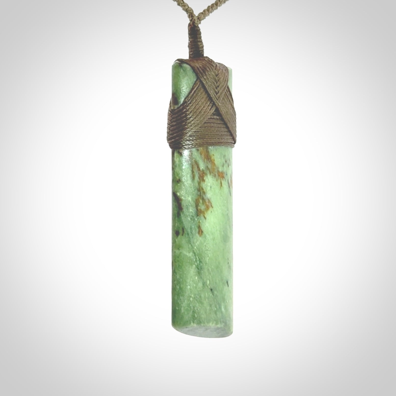 Hand carved from a lovely piece of local New Zealand Jade. We have suspended this from a 3-plait khaki cord which can be adjusted with a couple of slip knots and olive green binding.