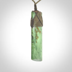 Hand carved from a lovely piece of local New Zealand Jade. We have suspended this from a 3-plait khaki cord which can be adjusted with a couple of slip knots and olive green binding.