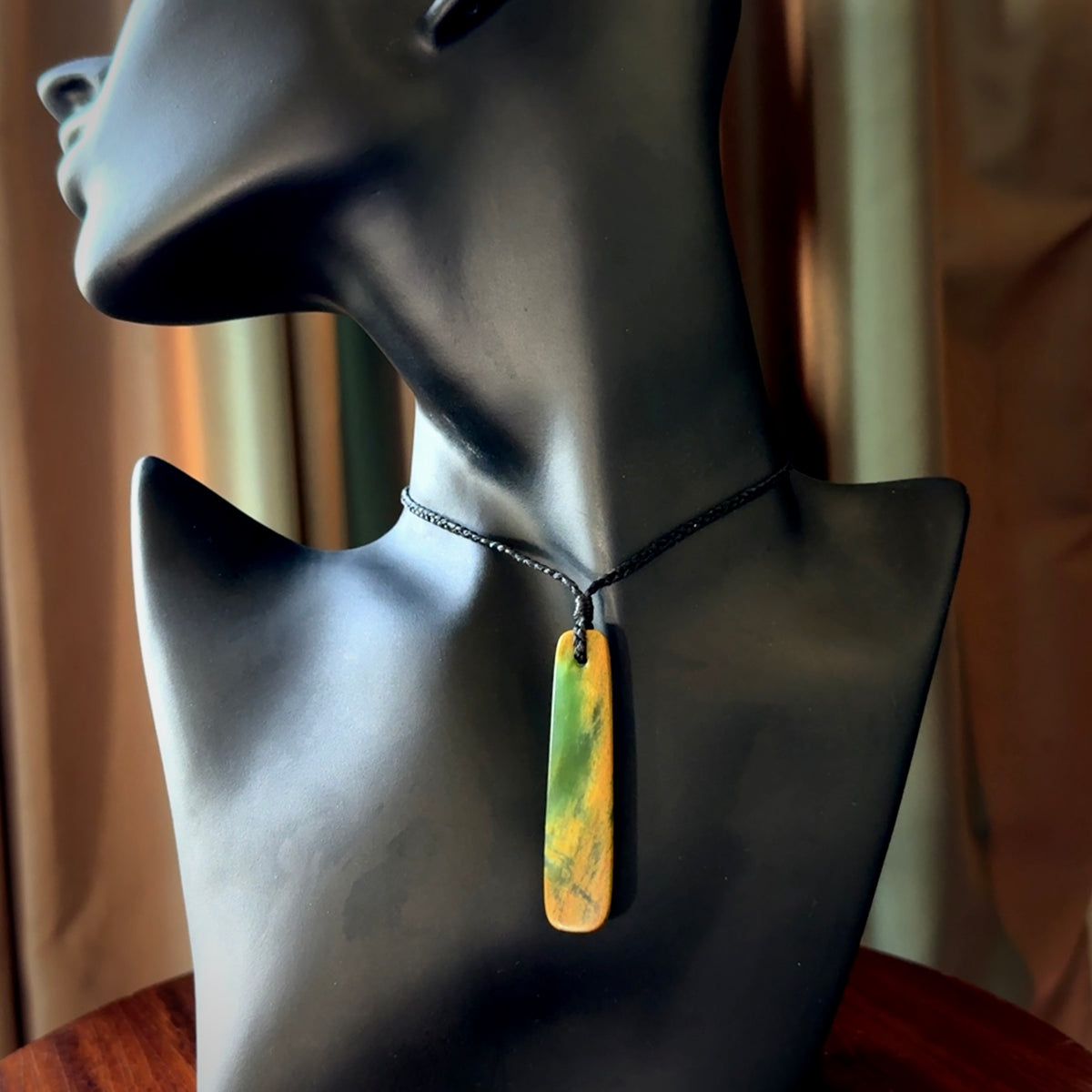 This is a lovely, medium sized, New Zealand Flower Jade, pounamu drop pendant. Hand carved Flower Jade Drop. It is bound with an adjustable black coloured cord which is length adjustable. Free worldwide shipping. One only necklace.