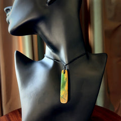 This is a lovely, medium sized, New Zealand Flower Jade, pounamu drop pendant. Hand carved Flower Jade Drop. It is bound with an adjustable black coloured cord which is length adjustable. Free worldwide shipping. One only necklace.
