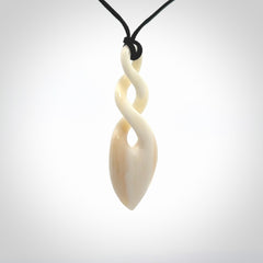 Hand carved bone double twist pendant. Beautiful hand made double twist bone necklace. Provided with an adjustable cord and packaged in a woven kete pouch. Free shipping worldwide.