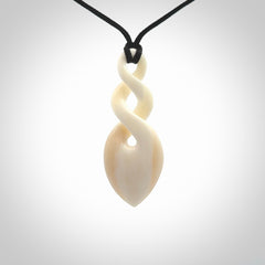 Hand carved bone double twist pendant. Beautiful hand made double twist bone necklace. Provided with an adjustable cord and packaged in a woven kete pouch. Free shipping worldwide.