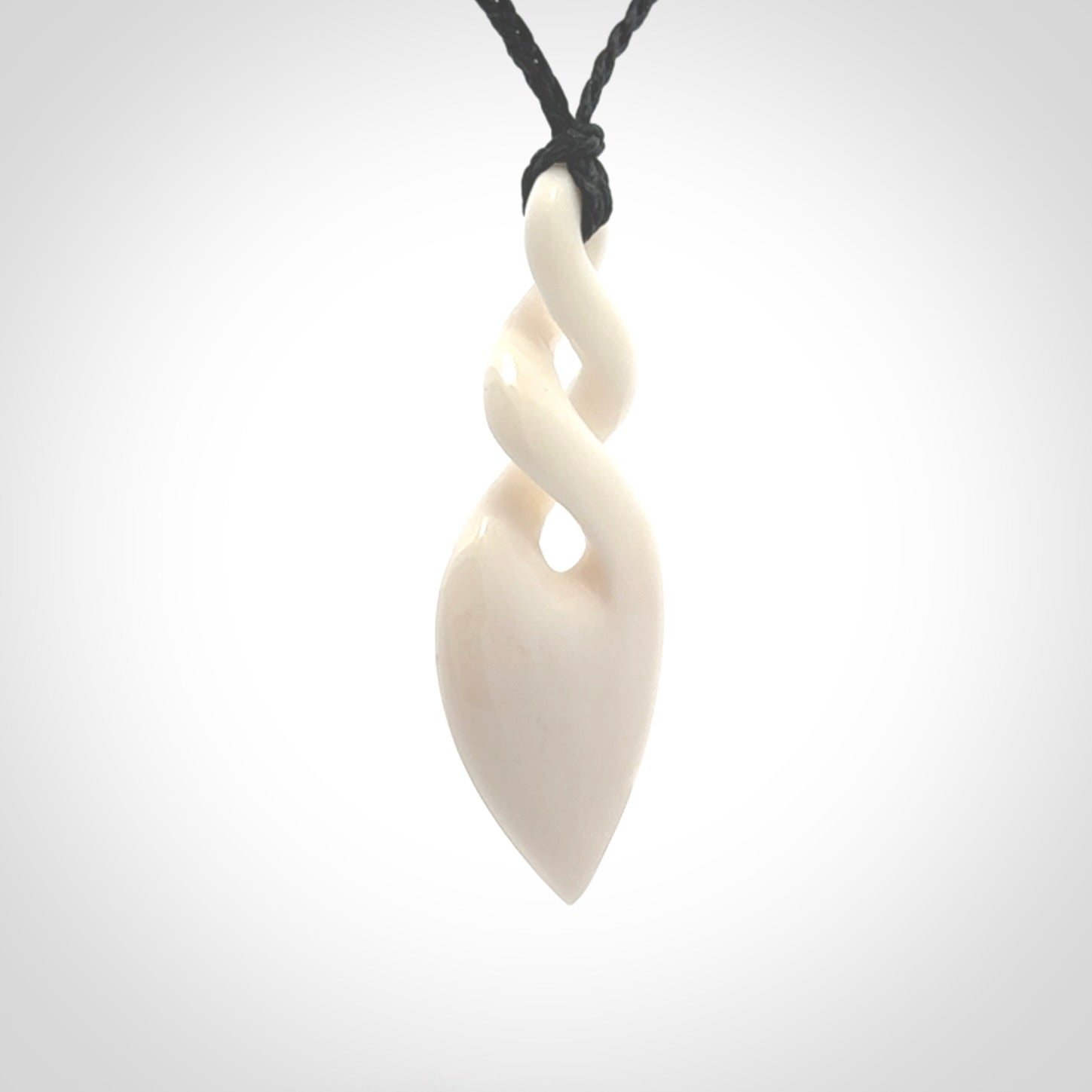 Hand carved bone double twist pendant. Beautiful hand made double twist bone necklace. Provided with an adjustable cord and packaged in a woven kete pouch. Free shipping worldwide.