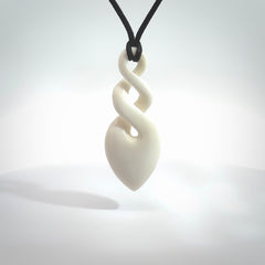 Hand carved bone double twist pendant. Beautiful hand made double twist bone necklace. Provided with an adjustable cord and packaged in a woven kete pouch. Free shipping worldwide.