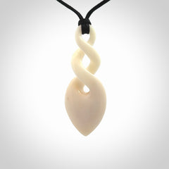 Hand carved bone double twist pendant. Beautiful hand made double twist bone necklace. Provided with an adjustable cord and packaged in a woven kete pouch. Free shipping worldwide.