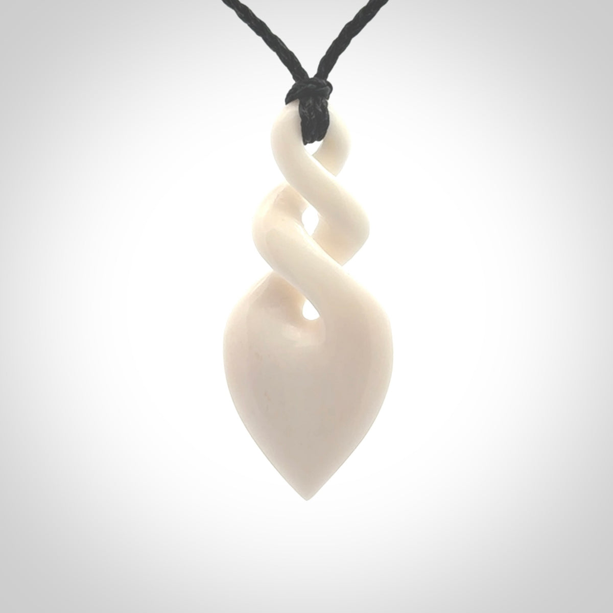 Hand carved bone double twist pendant. Beautiful hand made double twist bone necklace. Provided with an adjustable cord and packaged in a woven kete pouch. Free shipping worldwide.