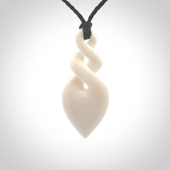 Hand carved bone double twist pendant. Beautiful hand made double twist bone necklace. Provided with an adjustable cord and packaged in a woven kete pouch. Free shipping worldwide.