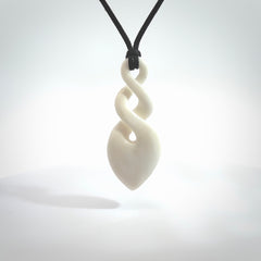 Hand carved bone double twist pendant. Beautiful hand made double twist bone necklace. Provided with an adjustable cord and packaged in a woven kete pouch. Free shipping worldwide.