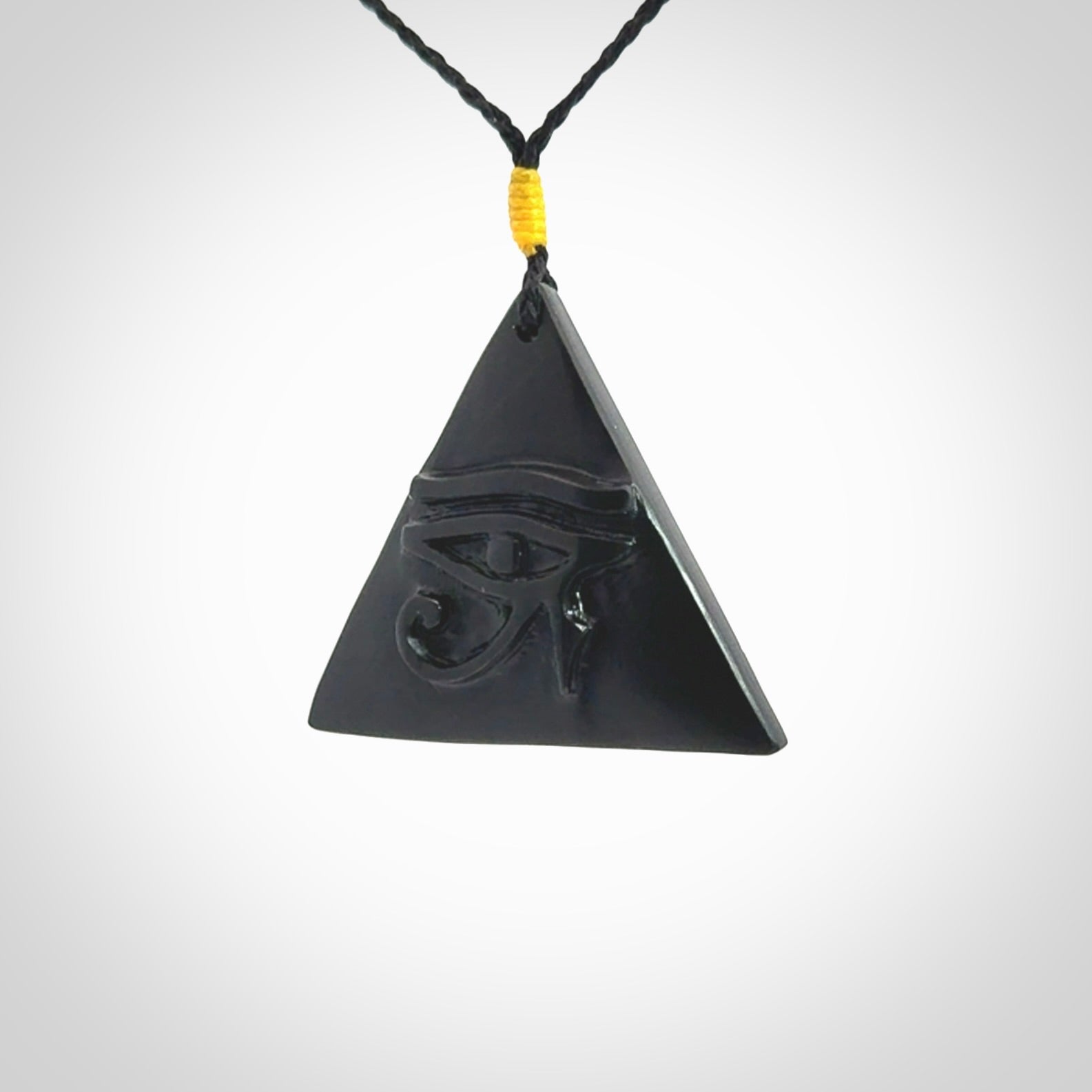 An Egyptian Eye of Ra pyramid pendant, hand made for us from Australian Black Jade. This pendant is provided with an adjustable black cord.