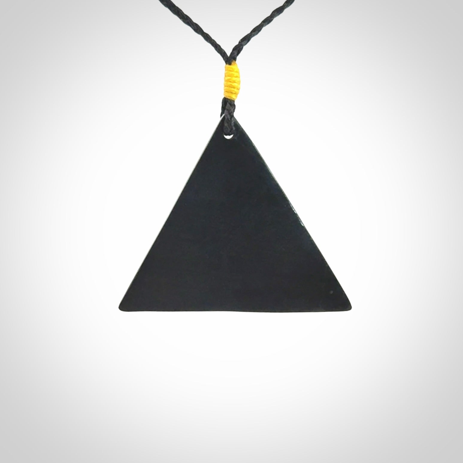 An Egyptian Eye of Ra pyramid pendant, hand made for us from Australian Black Jade. This pendant is provided with an adjustable black cord.