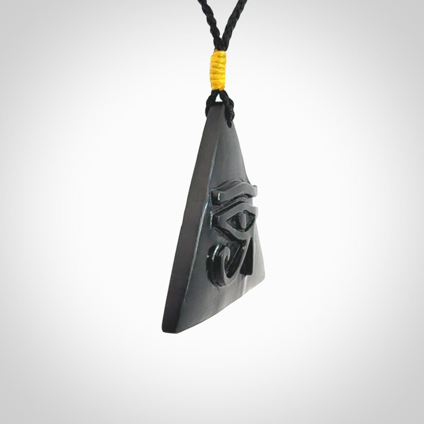 An Egyptian Eye of Ra pyramid pendant, hand made for us from Australian Black Jade. This pendant is provided with an adjustable black cord.